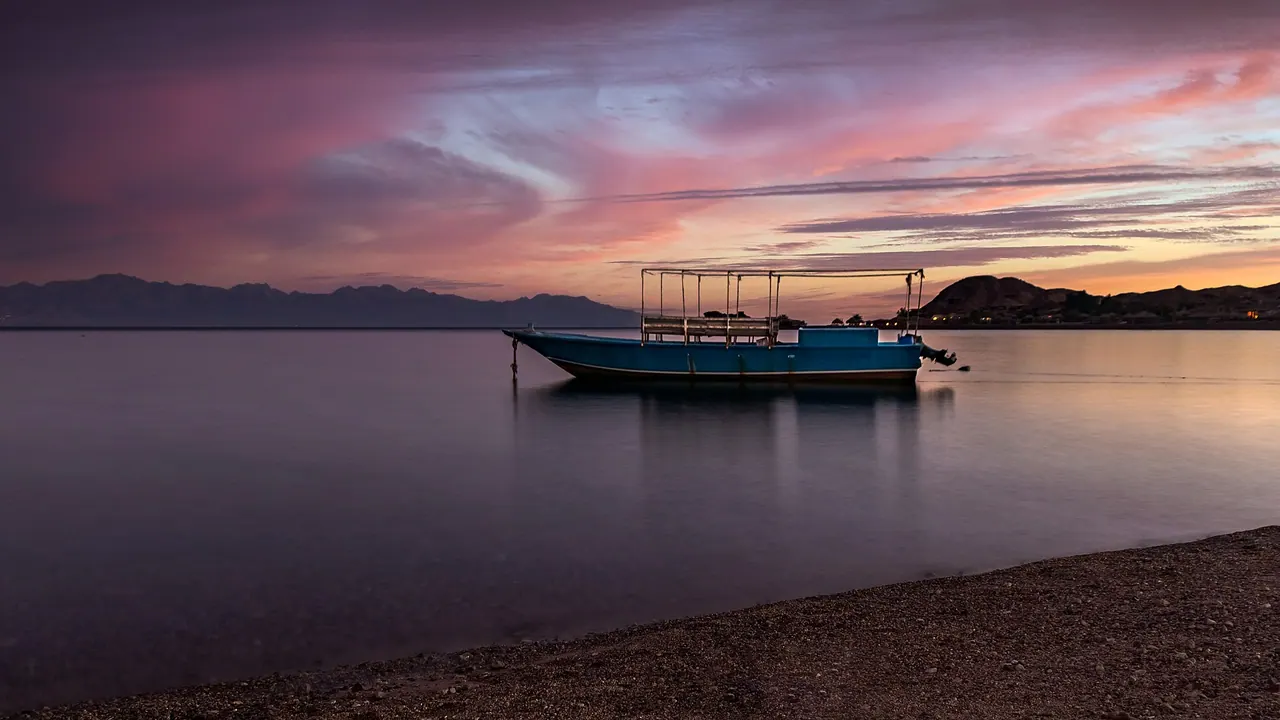 Boat at dusk off Ras Shitan